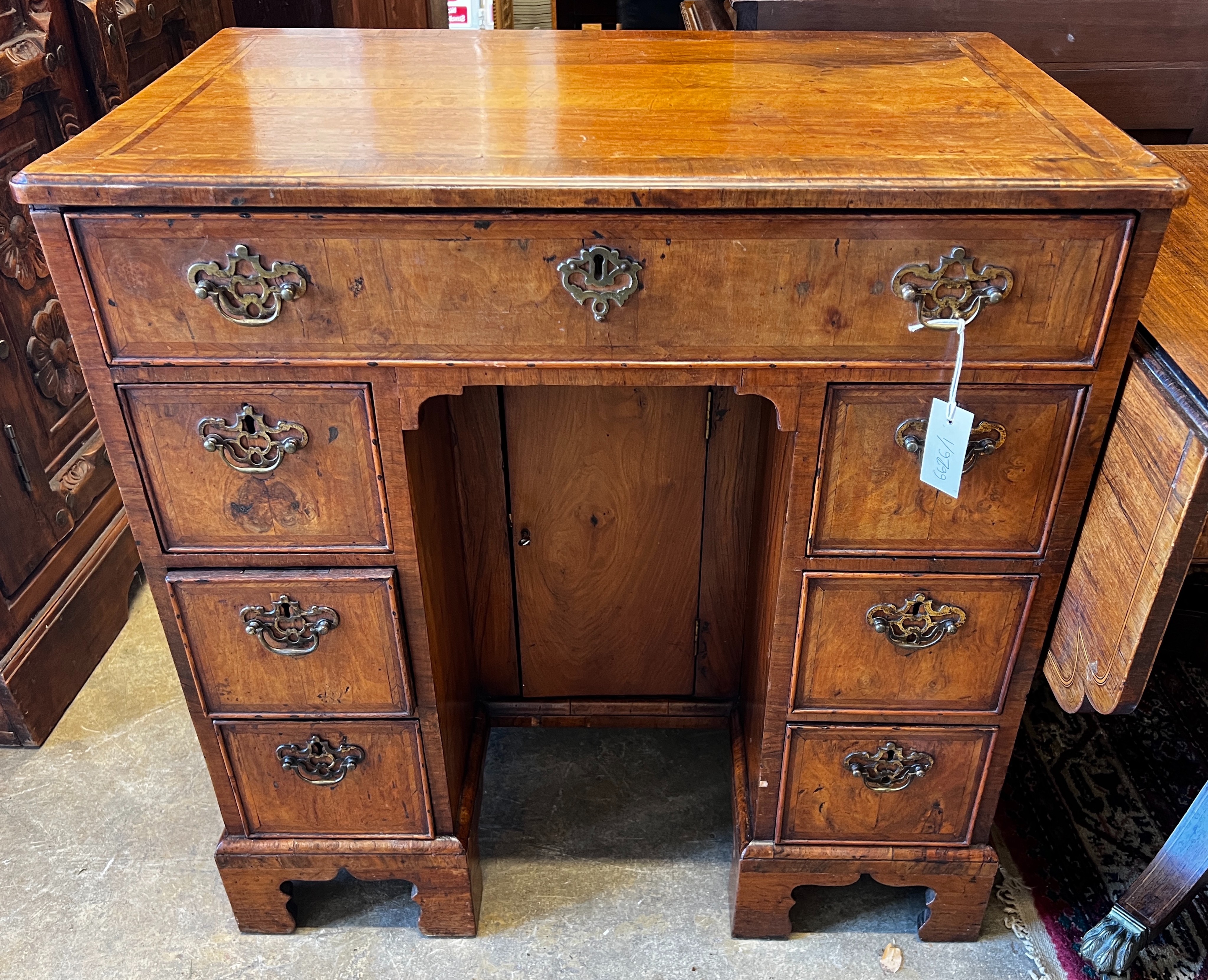 An 18th century feather banded walnut kneehole desk, length 78cm, depth 49cm, height 81cm